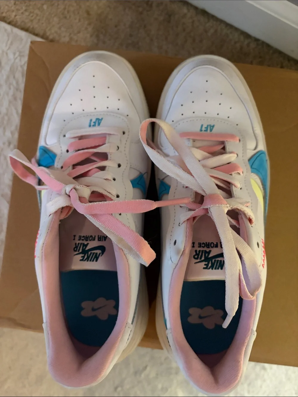 Nike Woman’s White Sneakers with Blue Swoosh and Pink Laces